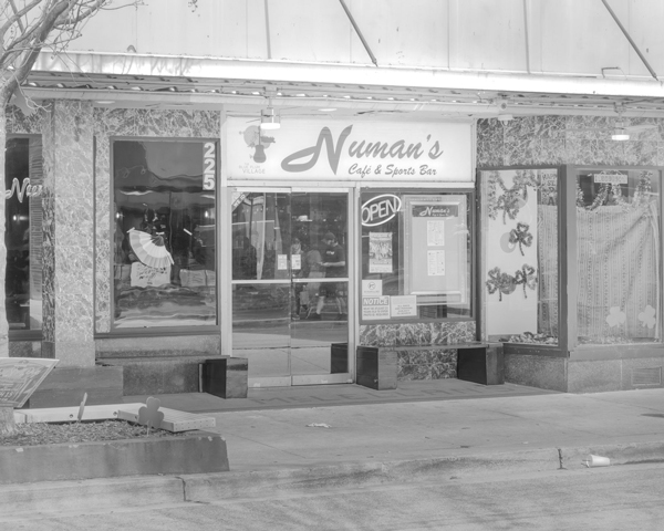 A blackandwhite photo of the front of Numan's bar.