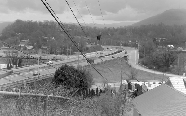 A blackandwhite photo of a highway.